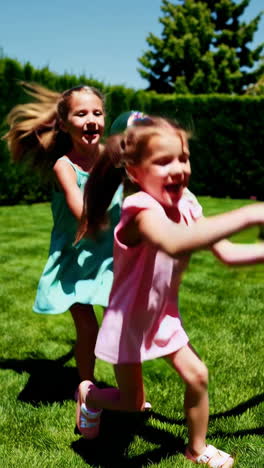 happy girls playing outdoors in the backyard