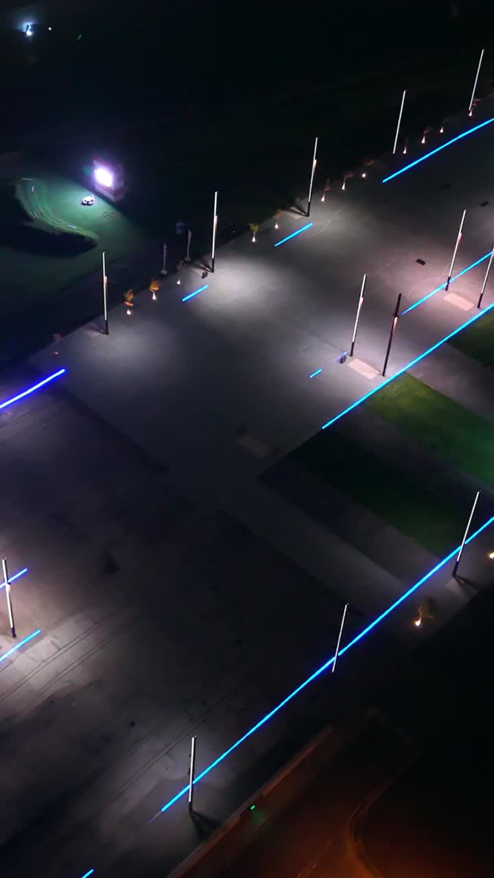 Overhead social ratio aerial video of the slipway at Titanic Belfast in Belfast, Northern Ireland at night. Produced in 60 frames per second, 1080x1920 and with Rec709 color