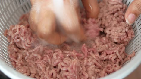 washing ground beef in a colander