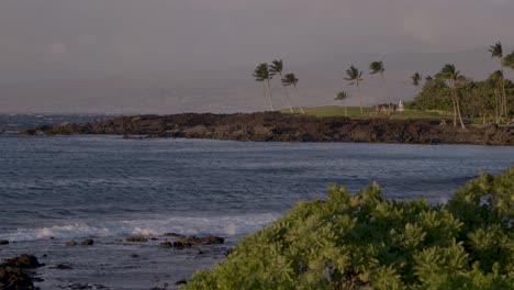 Slow-pan-from-island-out-onto-the-ocean-in-Hawaii,-in-the-evening