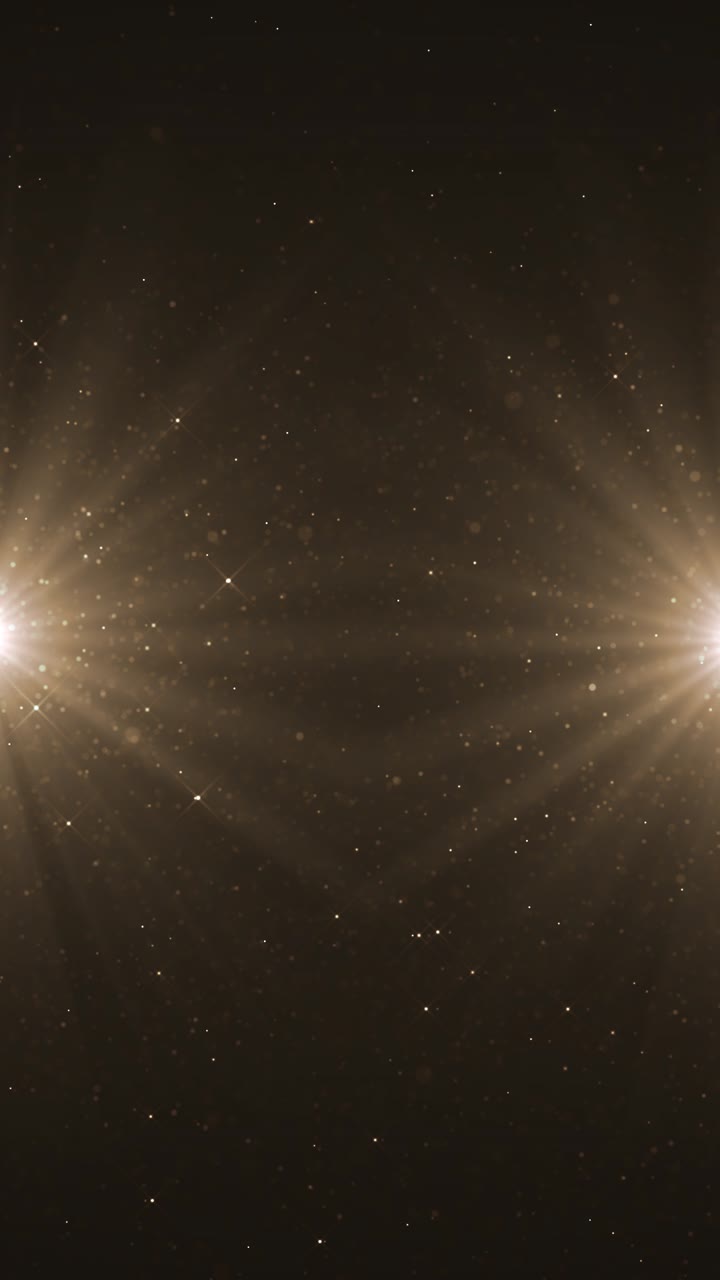 Golden sparkling particles glowing across dark space for award shows festive celebration luxury