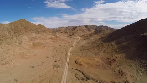 aerial footage of single 4x4 vehicle travelling through a desert