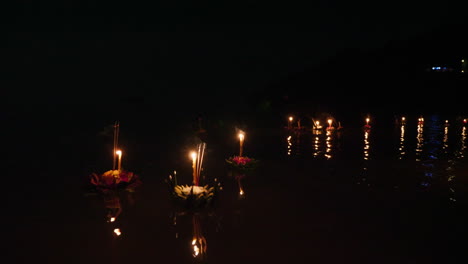 floating lanterns on water at night