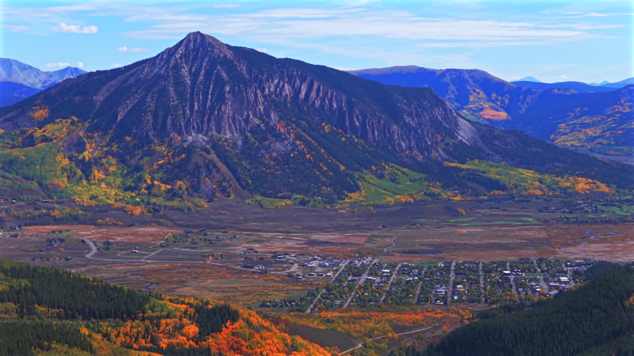 Crested Butte ski resort town drone aerial parallax circle left Mount Crested Butte Colorado autumn fall Elk Range Rocky Mountains quaking colorful Aspen Trees blue skies clouds Coal Creek Kebler Pass