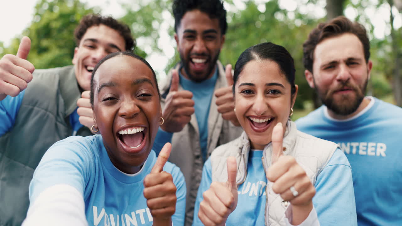Happy Diverse Group of Volunteers Giving Thumbs Up in a Park