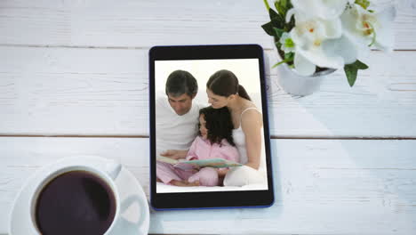 animation of a digital tablet showing a caucasian family on the screen