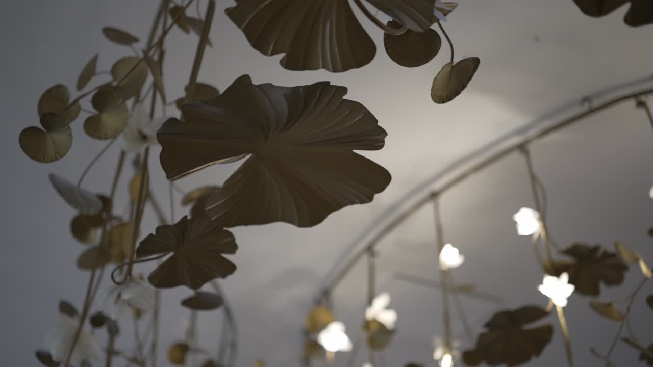 decorative metal leaf installation with soft, glowing lights, creating a warm and artistic ambiance in a dimly lit room
