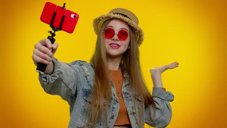 girl traveler blogger in sunglasses, taking selfie on mobile phone, communicating video call online