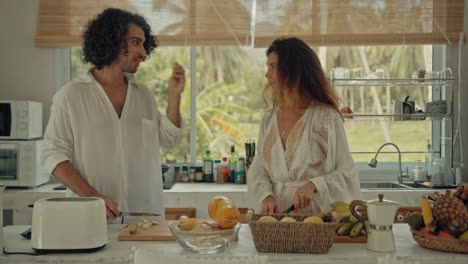 couple preparing breakfast in a tropical kitchen