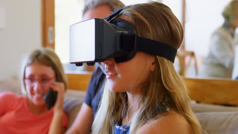 father looking at daughter using virtual reality headset 4k