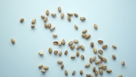 pistachios scattered on a white surface