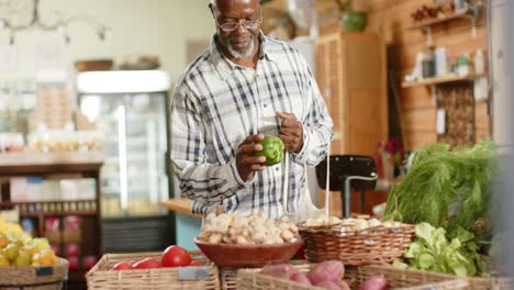 happy senior african american man shopping at health food shop, slow motion
