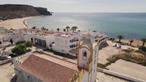 church of nossa senhora da luz overlooking the algarve coastline - aerial