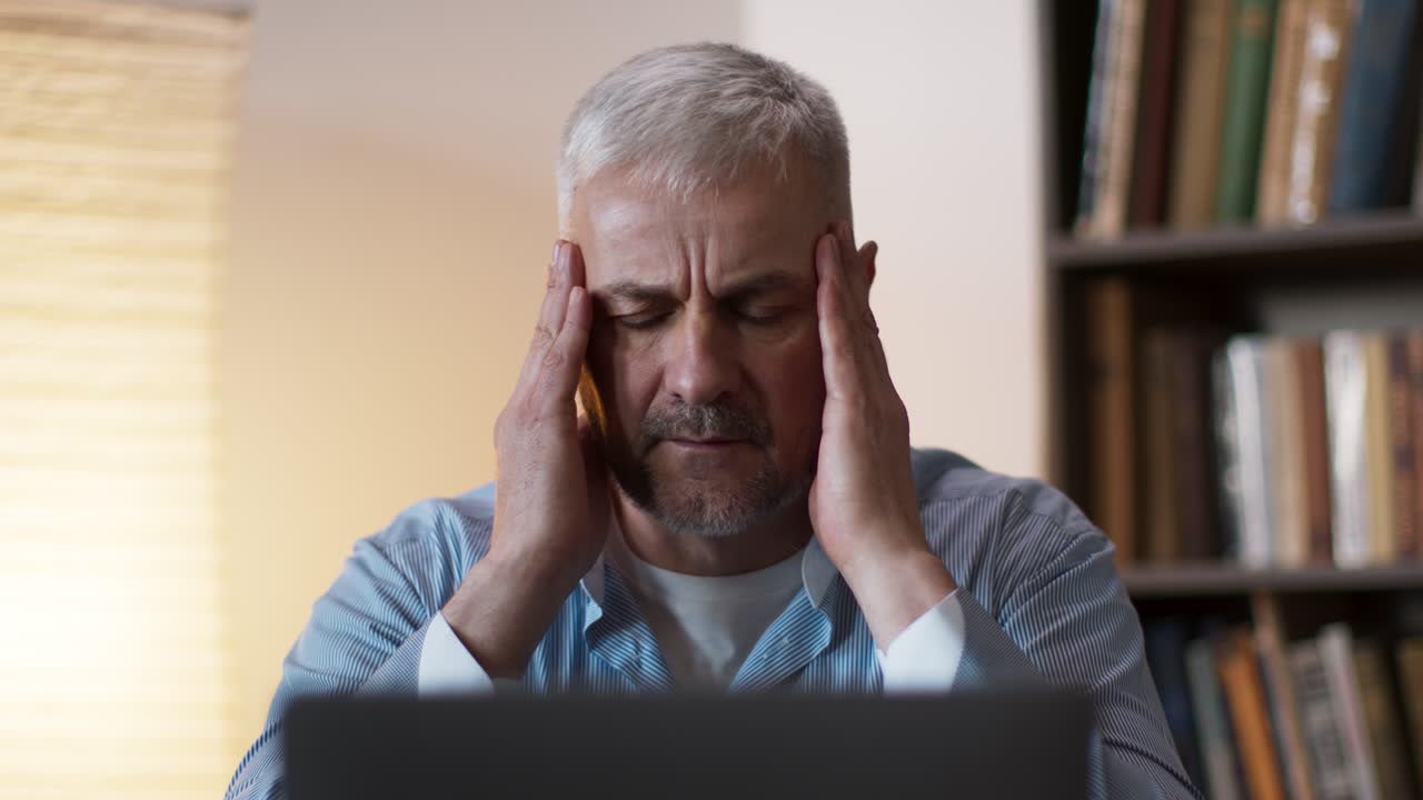 Stressed Man Working On Laptop