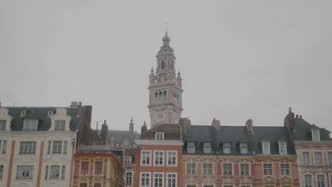 old facades in the centre of lille. bell tower of chamber of commerce in background