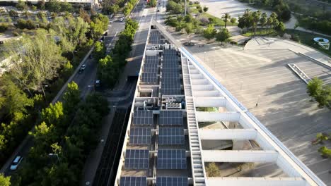 aerial view of photovoltaic panels on the roof of a structure to provide renewable energy - drone shot