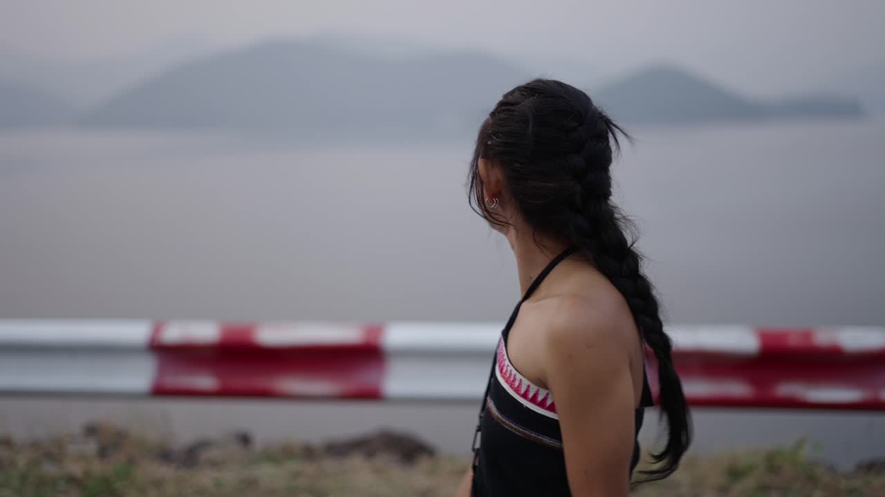 Young Woman Enjoying the Scenic Lake and Mountain View