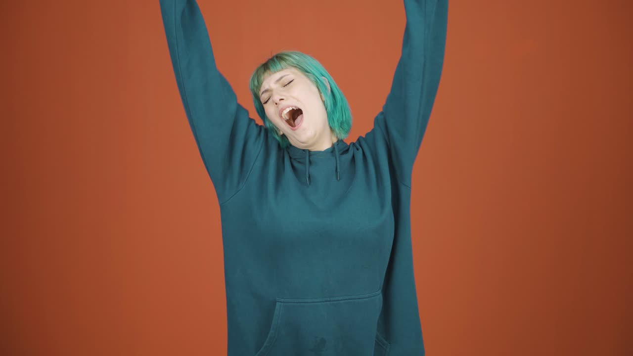 Sleepy young woman yawns.