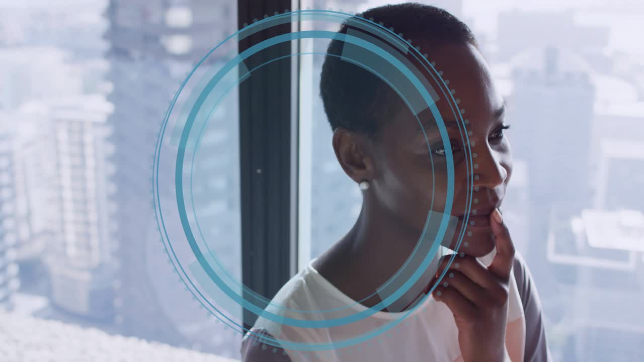 Woman holding chin in business office, blue HUD appearing expanding toward chin analyzing skyline