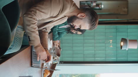 caucasian man working on laptop in cafe