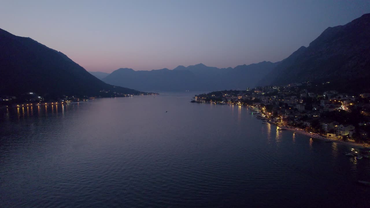 Twilight over Montenegro's Kotor Bay with illuminated coastline