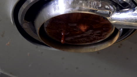 rich dark espresso being poured from machine