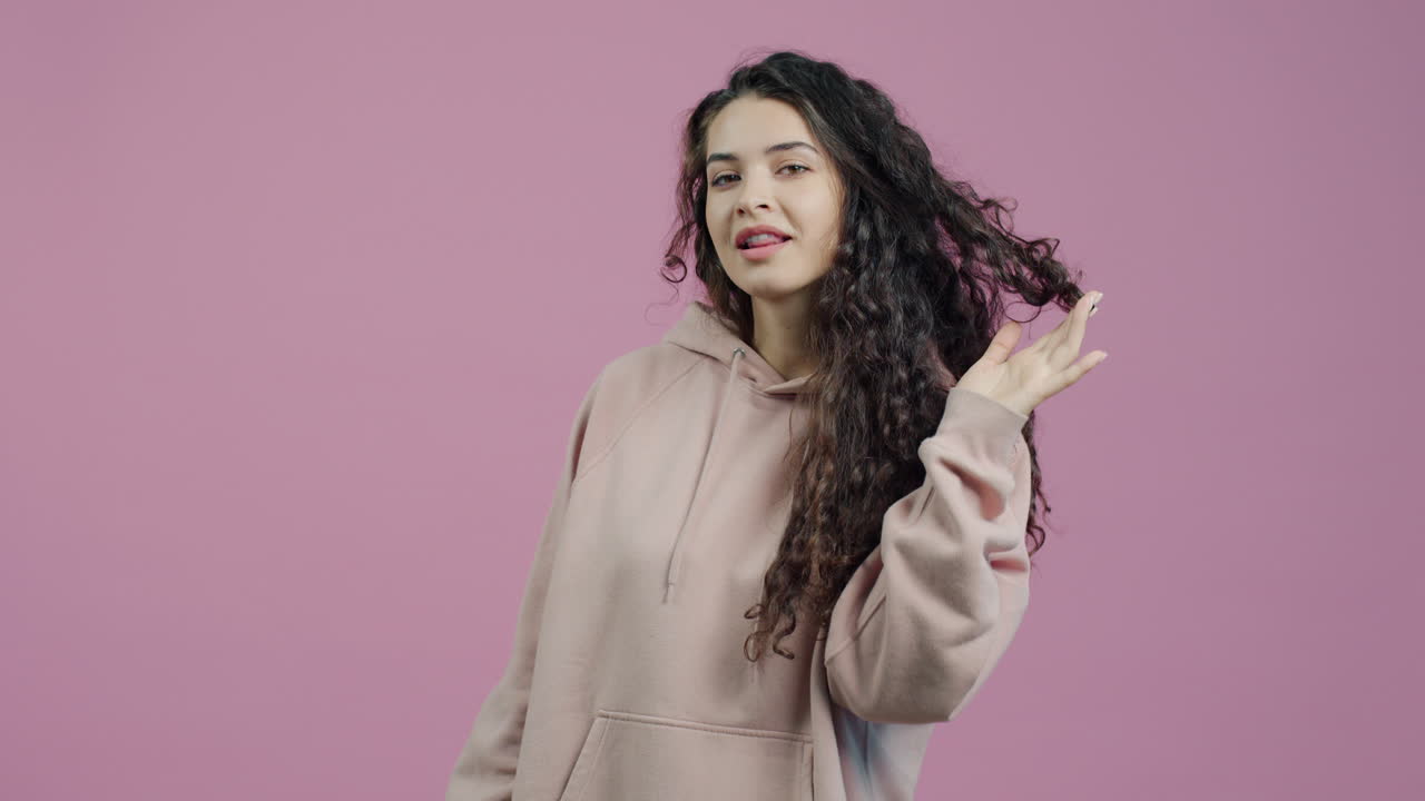 Woman with Curly Hair in a Hoodie