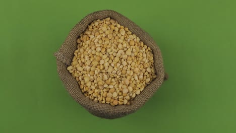 rotation of a full sack of peas grain. top view. isolated