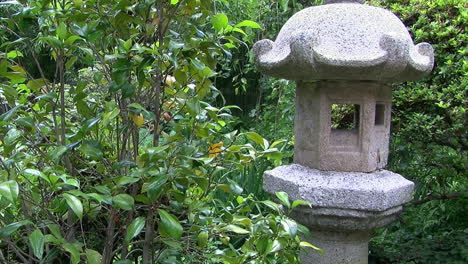 jib shot moves to view of stone lantern in a japanese garden