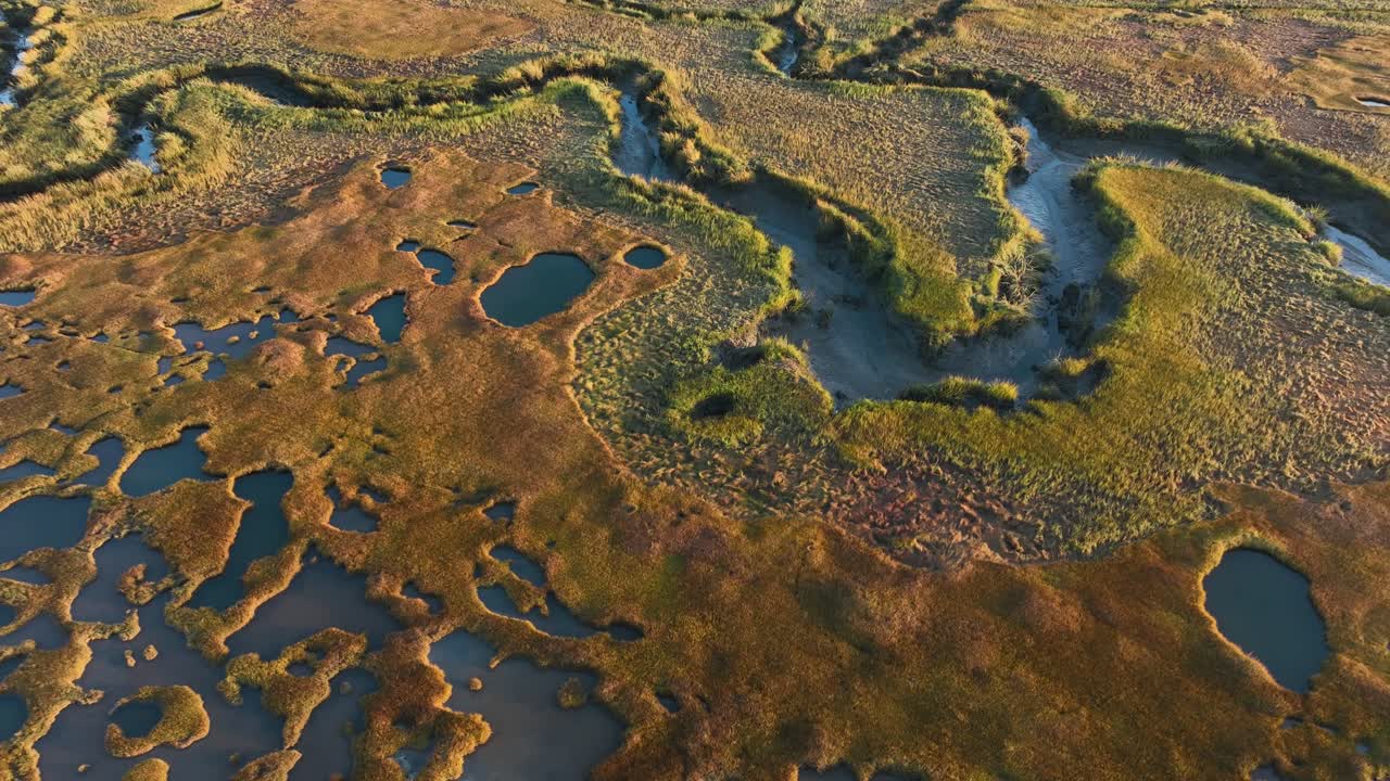 Aerial view over the rugged landscape of the great salt marsh at cape cod at sunrise.