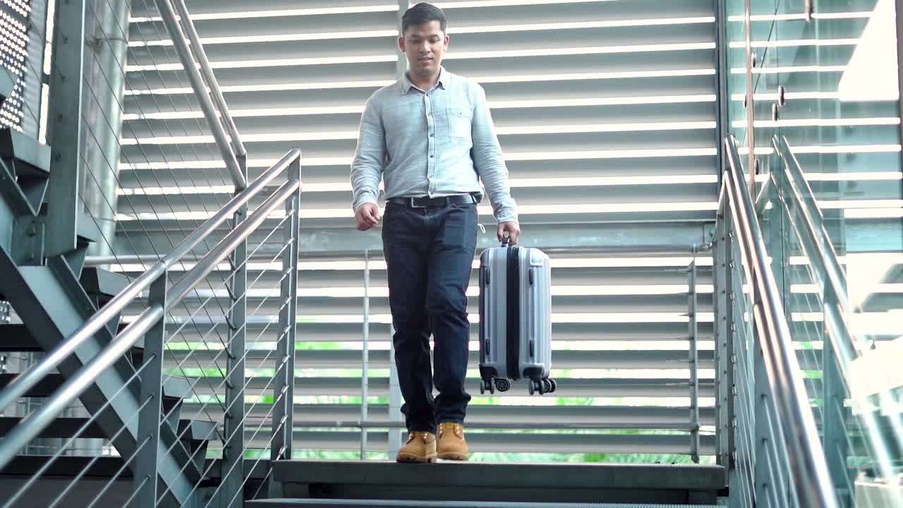 traveler man with suit case walking on stair
