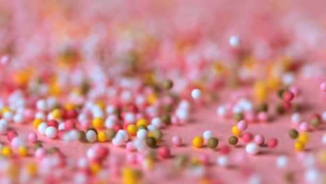 sprinkles falling on pink surface