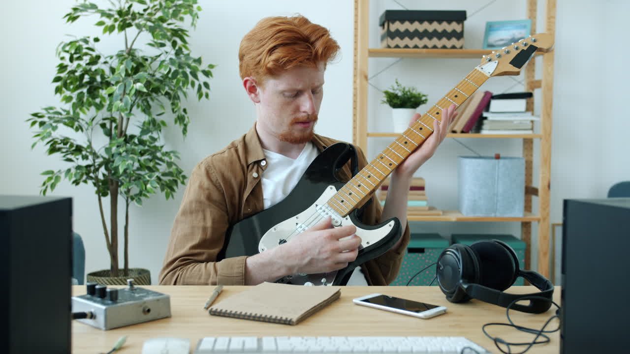 Man teaching guitar online