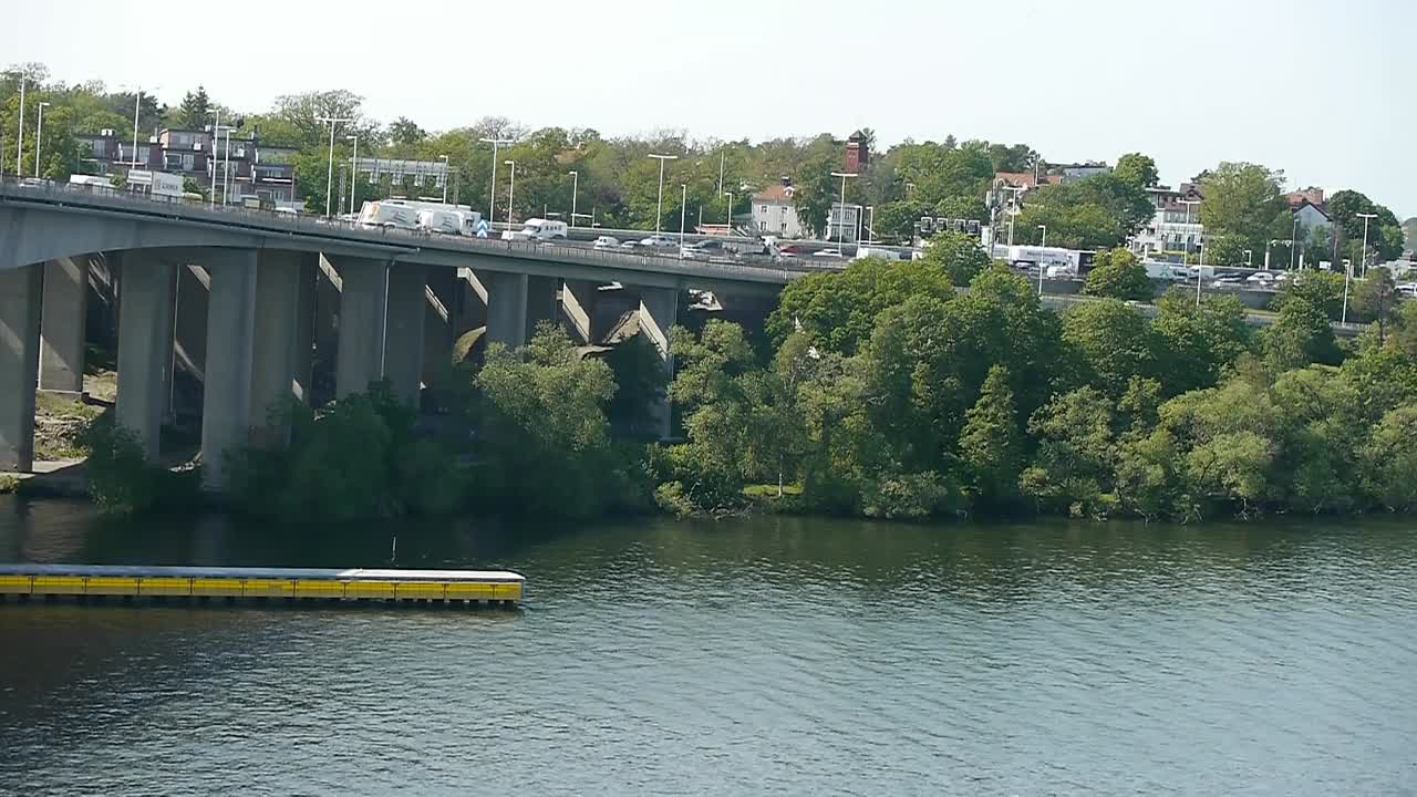 Traffic moving slowly on a bridge in central Stockholm on a clear sunny day in June 2019.