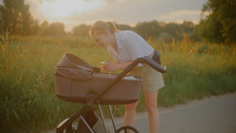 woman and baby stroller sunset walk