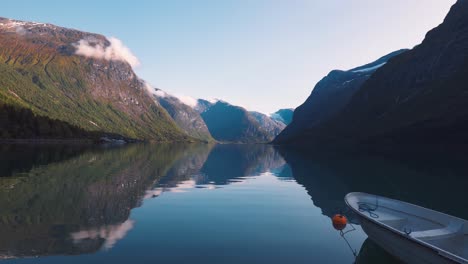 amazing serene view of a calm lake surrounded by mountains at norway lovatnet