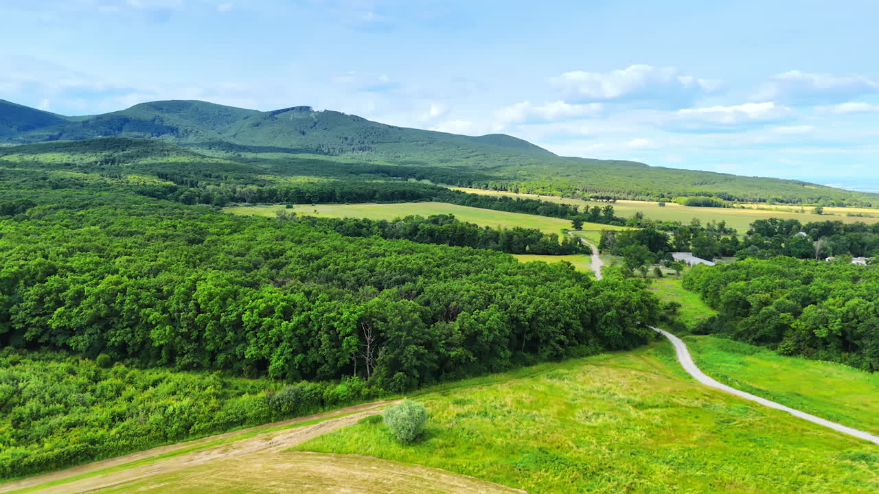 Nature landscape in summer. Drone footage over the scenery with lush forests and verdant mountains.