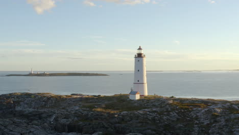 view of lille torungen lighthouse and store torungen lighthouse in distance, arendal in agder county, norway - aerial drone shot