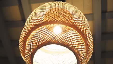 Woven-rattan-lampshade-glowing-warmly