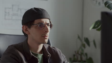 young architect focusing on computer screen during day in office