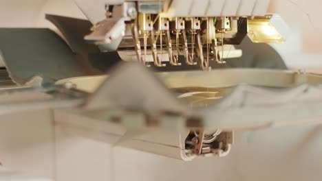 the automatic embroidery machine is working at high speed. close-up