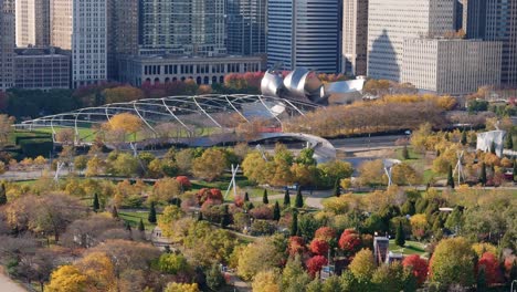 maggie daley park downtown chicago illinois, colorful fall foliage, aerial drone establishing shot 4k