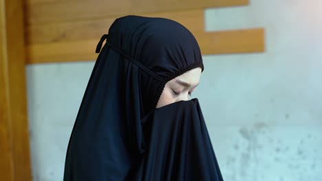 asian muslim woman praying and prostrating at home