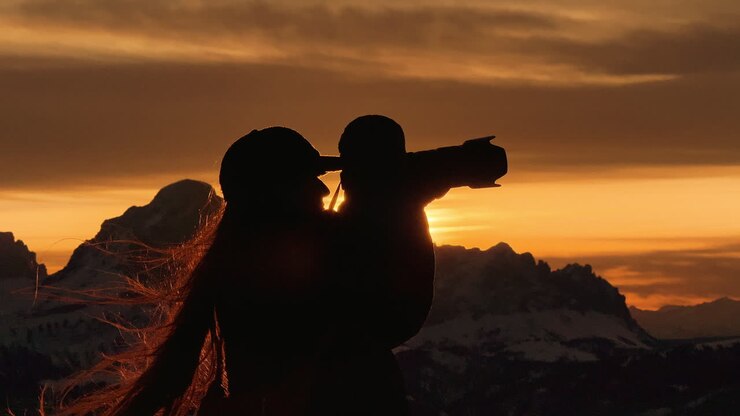 Silhouette of Photographer at Sunset in Mountains