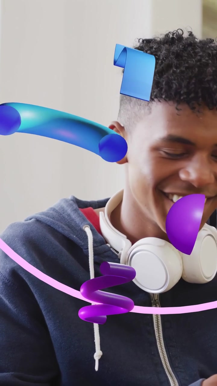 Vertical video: Teenage boy smiling, turning, following drifting 3D ribbons and reacting to AR