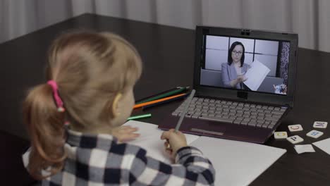 girl distance education lesson with woman teacher, using digital laptop at home