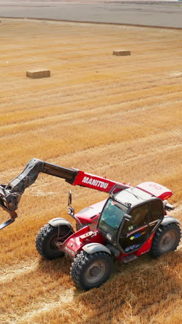 mavhine farming in the field. seasonal combine harvesting. vertical video