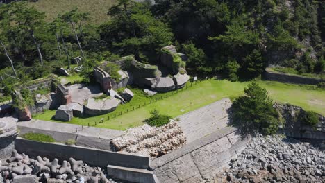 Aerial-pan-of-Tomogashima-island-ruins-of-brick-fort,-Wakayama-Japan