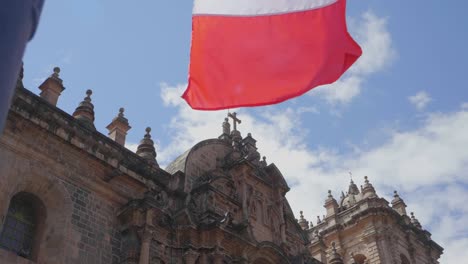 slow motion footage of the cathedral of cusco, peru, with waving flags