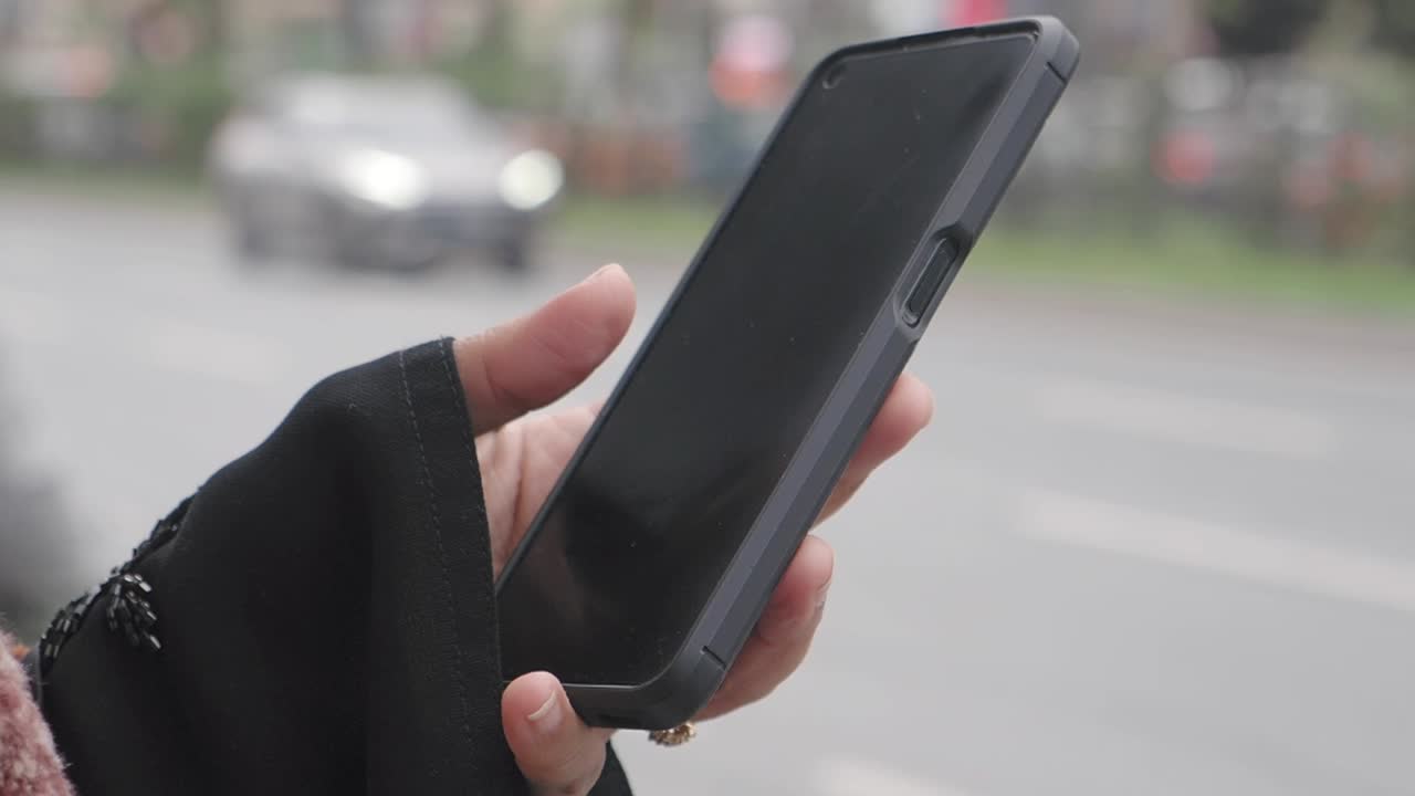 Woman using smartphone on the street